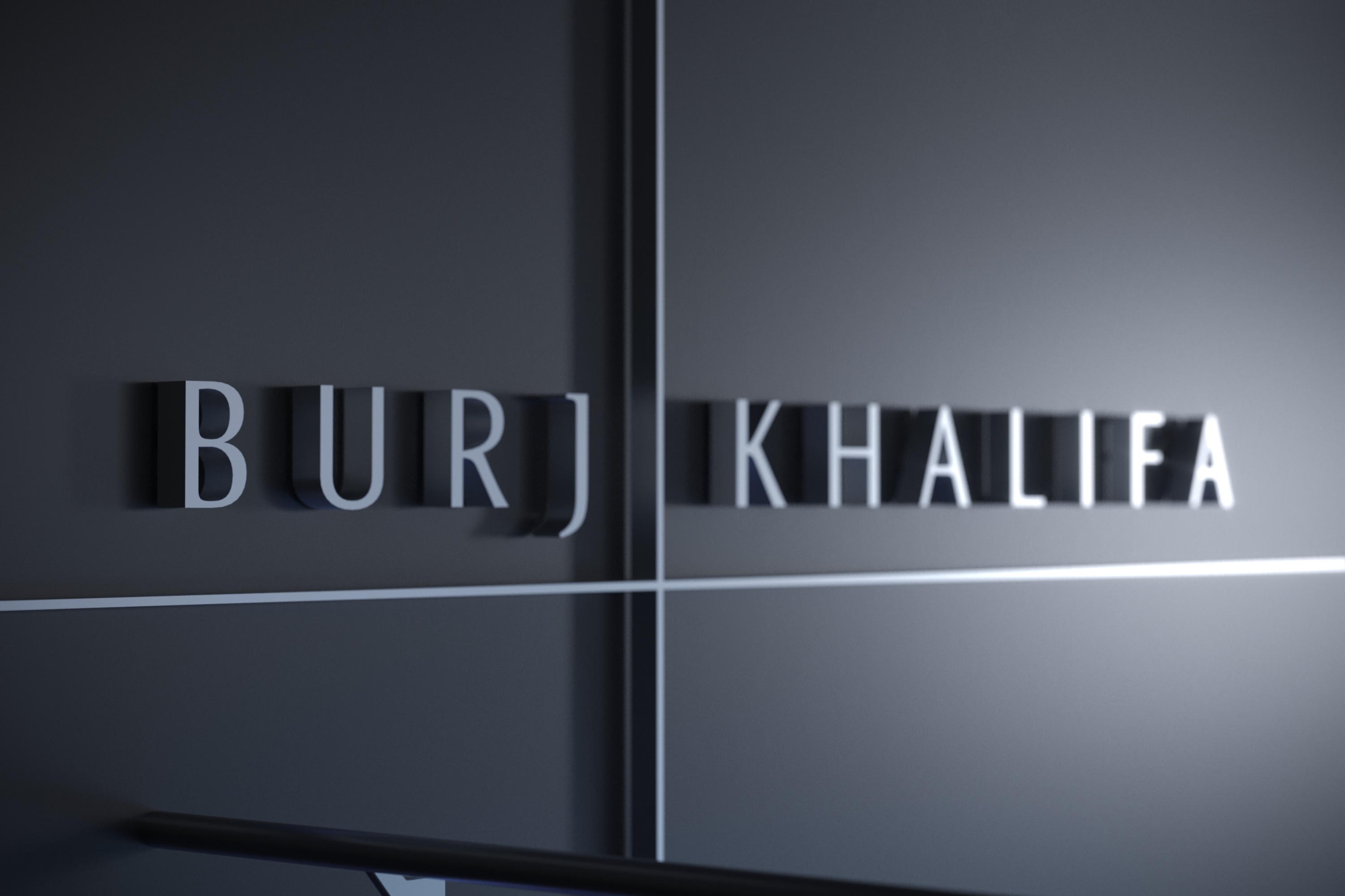 Burj Khalifa’s dimensional lettering on a dark architectural wall